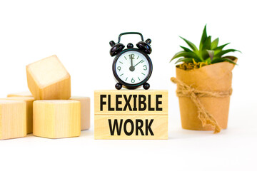 Flexible work symbol. Concept words Flexible work on beautiful wooden block. Beautiful white paper background. Black alarm clock. Business Flexible work concept. Copy space.