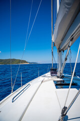 Wall Mural - Yacht sailing near Croatia coast. Close-up view of the deck, mast and sails. Yachting concept