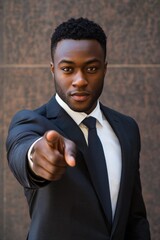 Wall Mural - A handsome businessman pointing at the camera