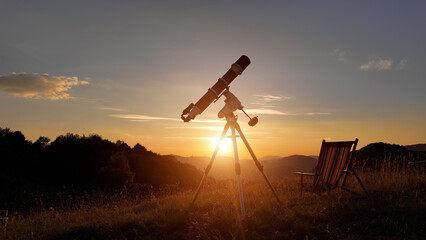 Wall Mural - Preparing for night sky observing with a astronomical telescope just before sunset.