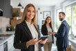 © GlooStock - Smiling businesswoman holding a tablet, standing confidently in a modern office space with colleagues discussing in the background. The image represents leadership, teamwork