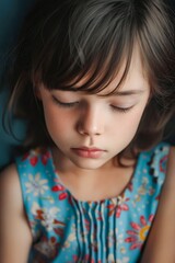 Poster - A little girl with her eyes closed and her head resting on her hands.