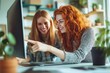 © GlooStock - Two young women smiling and working together at a computer in a bright, modern office. One points at the screen while the other listens and laughs, showcasing teamwork, creativity