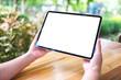 © Farknot Architect - Mockup image of a woman holding digital tablet with blank white desktop screen in the outdoors