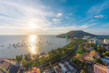 Panoramic view of Vung Tau sea from above with waves, coastline, streets, coconut trees and Tao Phung mountain in Vietnam. Travel concept