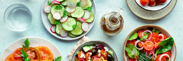 Wall Mural - Fresh vegetarian salads panorama, overhead flat lay shot of an assortment. Variety of plates and bowls with green vegetables. Healthy food, with olive oil