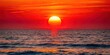 © Sujid - Vibrant red sun setting over calm ocean waters, sunset, beauty, red, sky, horizon, ocean, water, romantic, serene, peaceful