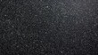 © Fleuronica - This textured black granite surface showcases fine particles and intricate patterns illuminated by natural light