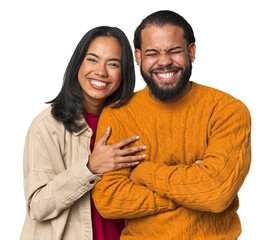 young latino couple in studio laughing and having fun.