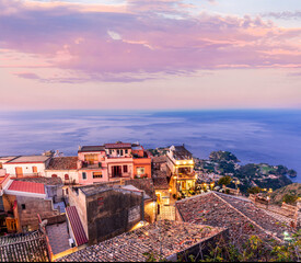 Wall Mural - beautiful travel town view from a mountain to roofs and houses, valley and sea gulf with scenic cloudy sunrise or sunset on background of landscape