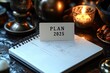 © ibnu - Notepad with plan for 2025 is open on desk with candles in background
