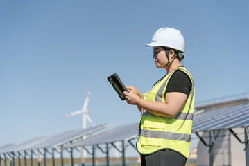 female technician working with tablet in solar power station