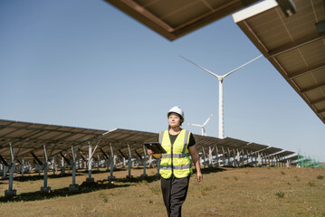 female technician working with tablet in solar power station