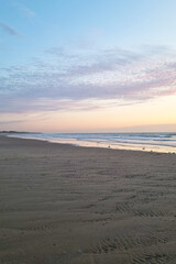 Wall Mural - Serene Early Morning Beach Sunrise with Soft Ocean Waves and Pastel Sky