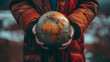 © Евгений Архипов - Close-up of a person holding a globe, symbolizing global awareness and detailed globe textures