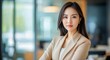 © Purichaya - Elegant Asian businesswoman in a chic outfit, modern office environment, poised and confident, Portrait, Corporate poise