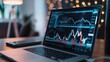 © sambath - Graphs and charts displaying financial growth on a laptop screen.