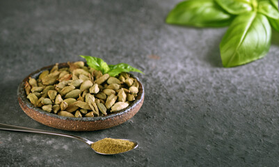 Wall Mural - organic cardamom spice in bowl on table