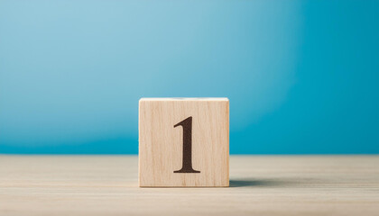 Fototapete - Wooden cube with number 1 one on wooden table with blue wall on background. Close-up.