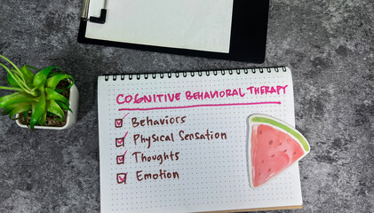 Wall Mural - Concept of Cognitive Behavioral Therapy write on book with keyword isolated on Wooden Table.