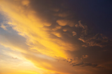 Poster - Beautiful sky with unusual red clouds on a sunset. Natural background in orange tones.