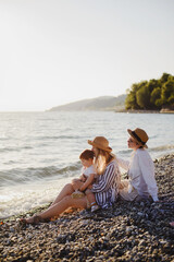 Family by the sea at sunset