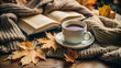 © Olena - Autumn. Warm, cozy scene with a cup of hot coffee or tea, surrounded by autumn leaves, a soft blanket and a good book. Abstract background.