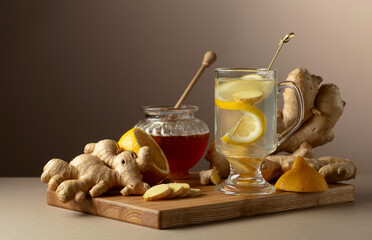 Wall Mural - Ginger tea with lemon and honey on a beige background.