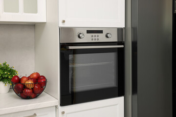 Wall Mural - Electric oven and apples in kitchen. Cooking appliance