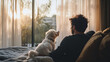 © Erika - hombre sentado junto con su amigo el perro disfrutando de un hermoso dia viendo el paisaje por un ventanal disfrutando de su amistad y de un dia relajado y feliz tranquilidad juntos