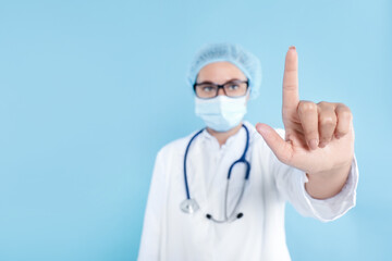 Wall Mural - Doctor pointing at something on light blue background, selective focus. Space for text