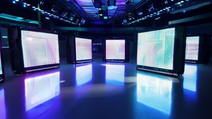 Poster - This Colorful LED screens illuminate a modern studio space at night.