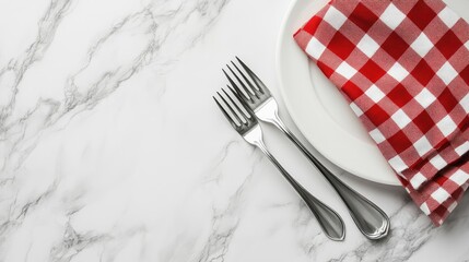 A holiday table is beautifully arranged with a white plate and red checkered napkin among pine cones and red ornaments, evoking a warm festive atmosphere