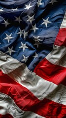 A flag with stars and stripes is shown in a close up. The flag is red, white, and blue