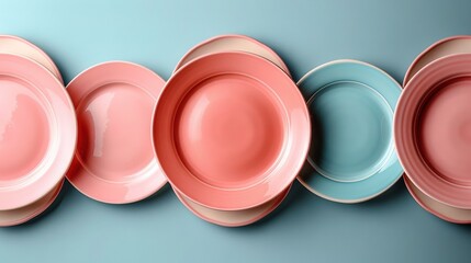 Wall Mural -   A row of pink and blue plates rests atop a blue and pink tablecloth