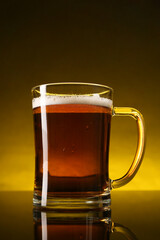 Wall Mural - Glass of beer with froth on dark table, closeup