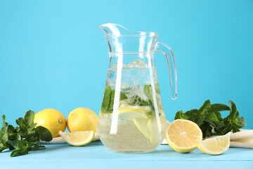 Canvas Print - Refreshing lemonade with mint in jug and ingredients on light blue wooden table