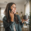 © Miljan Živković - Portrait of adult young woman stand hold cup and talk on mobile phone