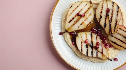 Wall Mural -  Sliced pears and pomegranates on white plate on pink tablecloth