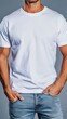 © Uliana - A white t-shirt mockup with a young man in jeans, hands in pockets, against a simple background, shot with natural light.