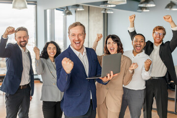 Aufkleber - A group of diverse business professionals celebrates a successful project in their modern office. The team is ecstatic, with smiles and raised fists, expressing their shared joy.
