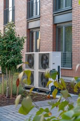 Poster - An air conditioner unit is situated outside a brick building, providing cooling services