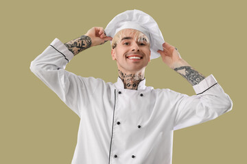 Poster - Tattooed male chef on green background