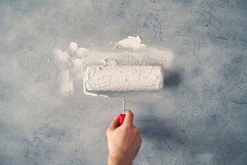 Poster - Person using a roller to paint a wall, straightforward and informative