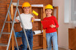 © Pixel-Shot - Little architects with paint roller and clipboard in room