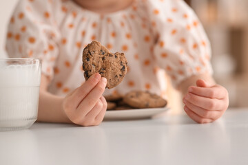 Wall Mural - Cute little girl with cookies and milk at home