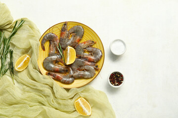 Sticker - Plate with fresh raw shrimps, lemon and rosemary on white background