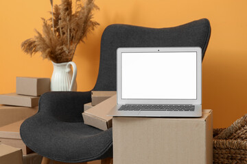 Canvas Print - Blank laptop on moving box in room, closeup