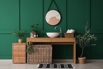 Poster - Table with sink, mirror, baskets and houseplants in interior of bathroom