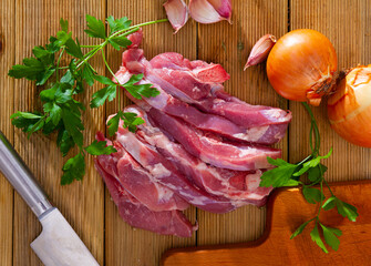 Wall Mural - Raw turkey thigh over the wooden background ready for cooking